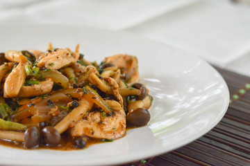 stir fried mushroom with black pepper, chicken breast, green onion on white dish. Thai delicious food. Low fat high protein and vitamins.