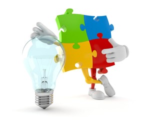 Jigsaw puzzle character with light bulb