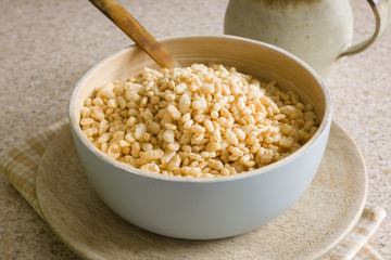 Puffed rice breakfast cereal in a wooden bowl