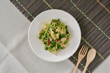  Stir fries Sunflower sprout with chicken breast mince and red dried chili on white dish for served in dinner. Healthy food, high fiber.