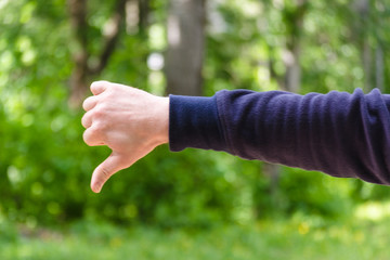 Thumb down hand sign. Gesture mens hand of dislike and negative. Concept of disagreement, disgust,...