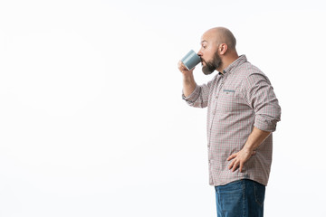 Handsome man with blue glasses drinking coffee