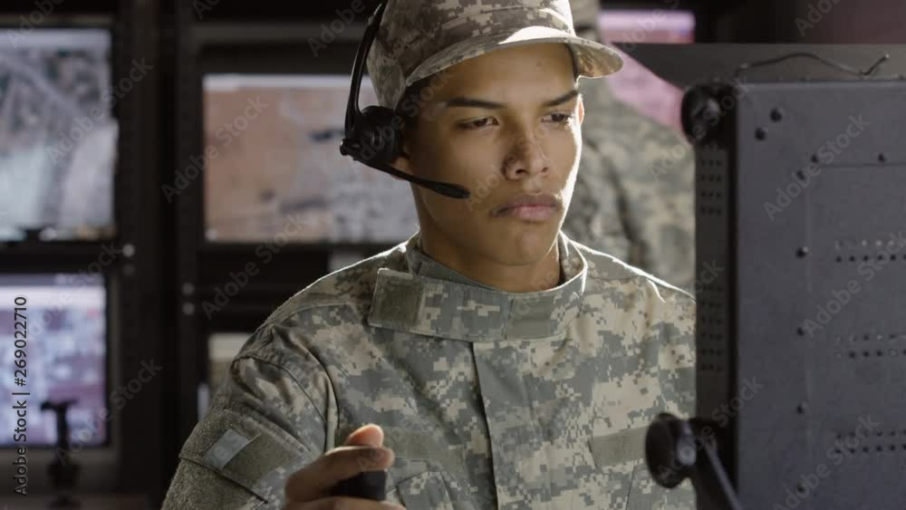 Wall mural military drone operator looking at computer screen