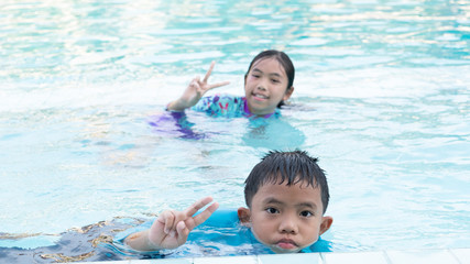 Fototapeta na wymiar Boys and girls have fun playing in the pool, In the summer and on holidays