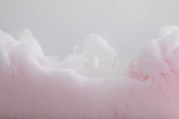 Fototapeta na wymiar Close up view of light pink paint swirls isolated on grey