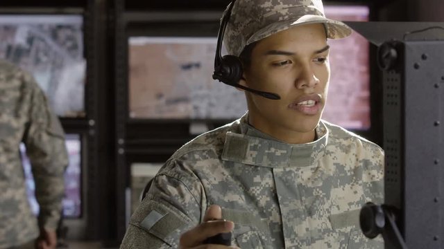Military drone operator talking in control room