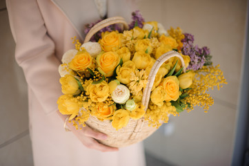 Beautiful bouquet of yellow flowers in basket