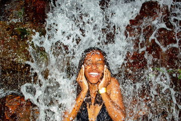 Black Woman Taking Bath From Waterfall