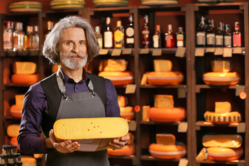 Business owner with cheese in his store