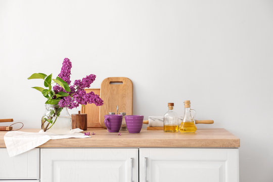 Beautiful lilac flowers on counter in kitchen