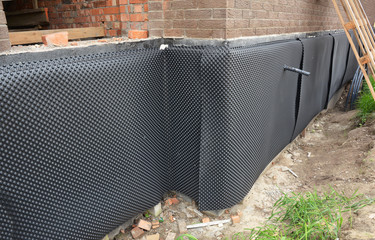 House foundation insulation details with waterproofing bitumen membrane, damp proofing. House...