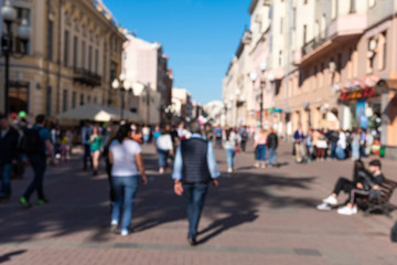 Blurred street of the old town on a sunny day with a crowd of people