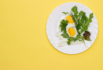boiled egg ready to eat and spiced on a plate with healthy ingredients