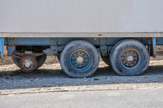 Cargo container trailer without one wheel breaking in the parking lot.