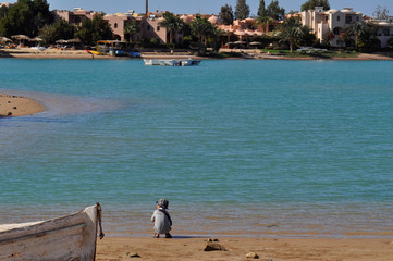 Small boy sitting alone on the beach, Red Sea El Gouna Egypt