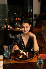 Asian Beautiful Woman have Dinner in luxury roof top restaurant with secret recipe Menu on plate course set of Spanish food Cuisine culinary which a bit hot and unique taste on wooden table.