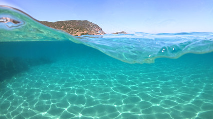 Underwater sea level photo of famous crystal clear turquoise sandy beach of Pori in Koufonisi...