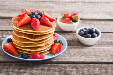 Tasty pancakes with blueberry and strawberry