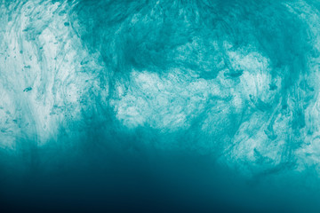 Close up view of blue paint swirls in water