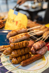 Sai Ua, the northen thai sausage on some wooden stick on a plate at a market in Chiang Mai, Thailand