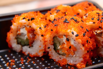 Bright tasty sushi with a large plan.