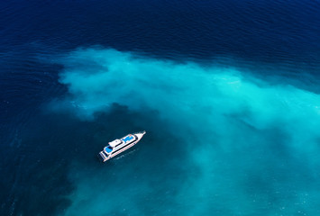 Fast boat at the sea in Bali, Indonesia. Aerial view of luxury floating boat on transparent...