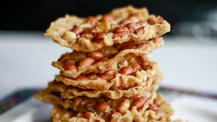 Peanut Peyek on plate. Peanut Rempeyek or Peyek is a deep-fried savoury Javanese cracker made from  rice flour with peanut by crispy flour batter. Indonesian food.