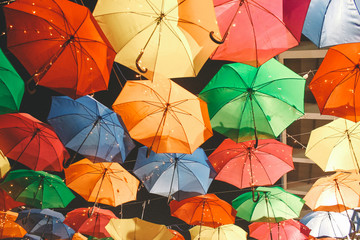 Fototapeta na wymiar Colored umbrellas hanging in festival days in Ho Chi Minh city, Vietnam