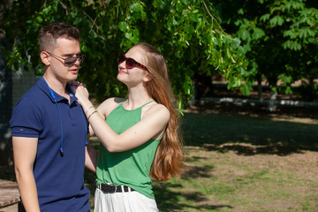 Happy young couple hugging and laughing outdoors.