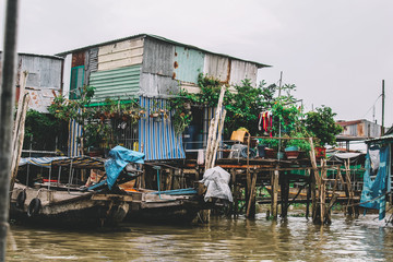 Fototapeta na wymiar Houses and boats on the water in Mekong delta, Can Tho, Vietnam.