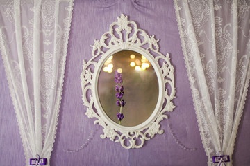 White vintage mirror on the wall. Close-up