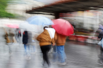 Walking under the rain with umbrella