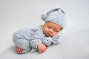 Fototapeten Sleeping newborn boy in the first days of life on white background © Oksana