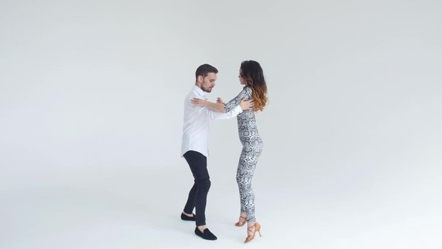 Concept of love, relationships and social dancing. Social dance, salsa, zouk, tango, kizomba concept - beautiful couple dancing bachata