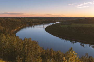Beautiful sunset over the North Saskatchewan River and Terwillegar Park Footbridge in Edmonton, Alberta, Canada