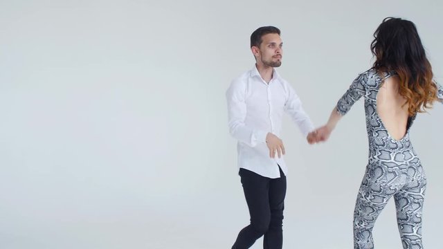 Concept of love, relationships and social dancing. Social dance, salsa, zouk, tango, kizomba concept - beautiful couple dancing bachata