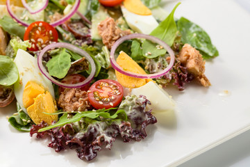 Green salad with egg , tuna and sesame