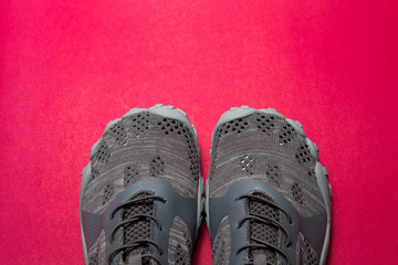 Sport gray sneakers isolated on purple background