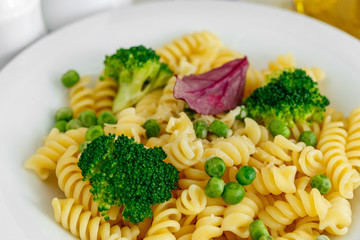 Pasta with broccoli and green peas