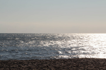 Empty sea, sand beach and blue sky background.