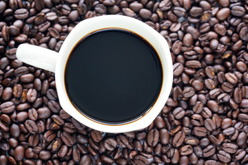Closeup a Cup of coffee and beans.