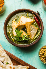 Palak Paneer curry is a popular North Indian recipe for lunch/dinner made using cottage cheese in green spinach curry. usually served with Rice and chapati/naan. selective focus