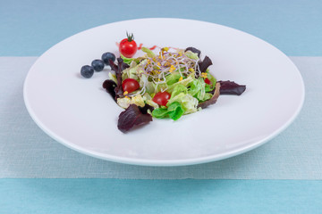 Mix of sprout beans salad isolated on a white plate. vegan, raw food diet