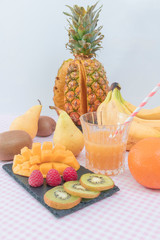Assortment of healthy raw fruits an raspberries oranges plums apples kiwis pineapple pear, mango. selective focus