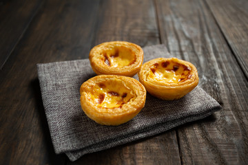 Egg tart on wooden background.