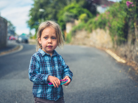 Little toddler standing in the street
