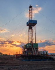 oil rig for drilling under oil and gas at sunset. Drilling oil and gas wells