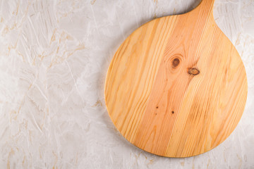 Wooden cutting board on a gray marble background