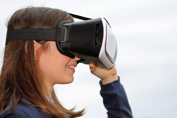 profile of a little girl with VR visor on white