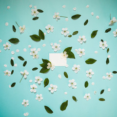 on a beautiful sky background, white wild cherry flowers and a white plate to insert text. For logo...